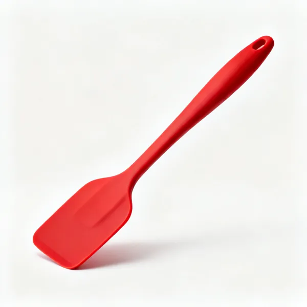 A red silicone spatula with a long handle