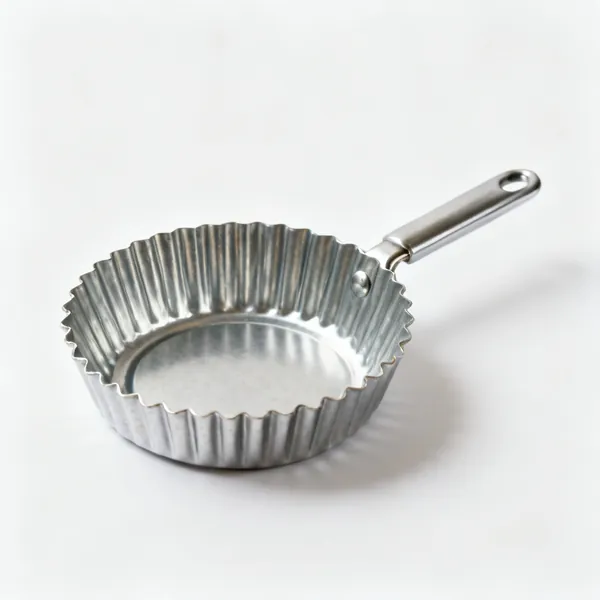 A fluted metal tart tin with a loose base