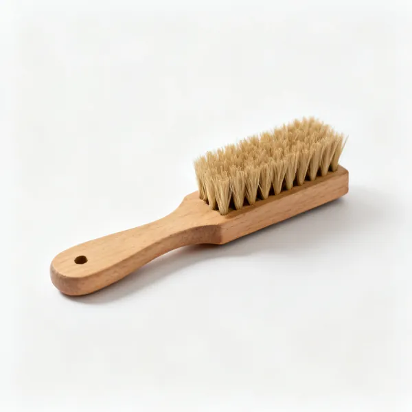 A small wooden handled bench brush with stiff natural bristles