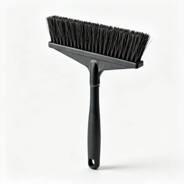 A stiff bristled yard brush