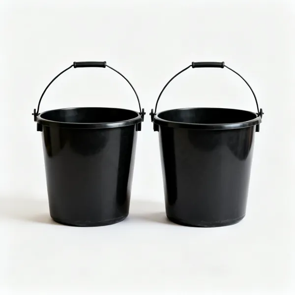 Mixing buckets: Two black plastic builders buckets side by side