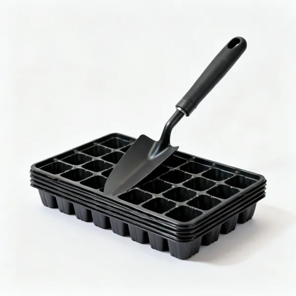 A stack of black plastic seed trays with cell divisions