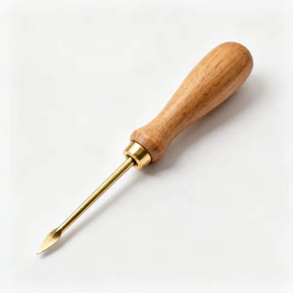 A wooden garden dibber with a brass tip
