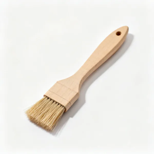 A small stiff bristled glue brush with a wooden handle