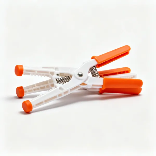 Several plastic spring clamps with orange handles and rubber tips