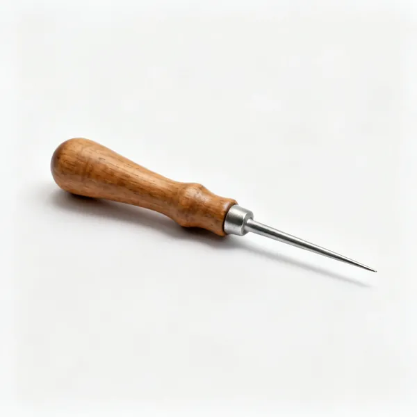 A scratch awl with a turned wooden handle and long round tapered steel point