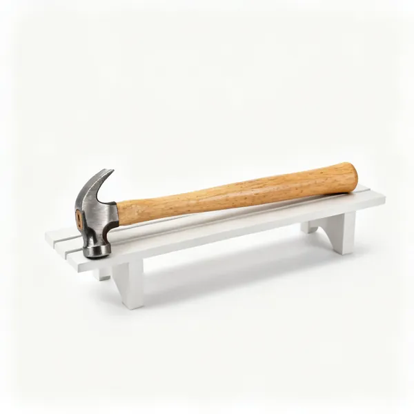 Spare handle: A hickory hammer replacement handle lying on a bench