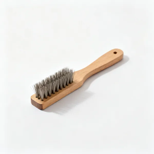 A file card cleaning brush with short stiff wire bristles and a wooden back