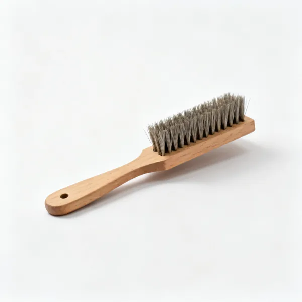 A file card cleaning brush with short stiff wire bristles on a wooden back