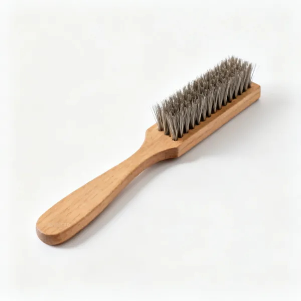 A file card cleaning brush with short stiff wire bristles on a wooden back