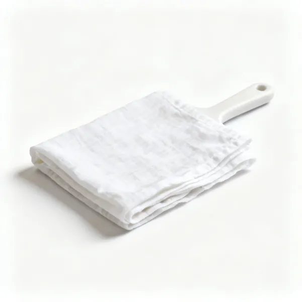 Cheesecloth / muslin: A folded piece of white loose-woven cheesecloth fabric
