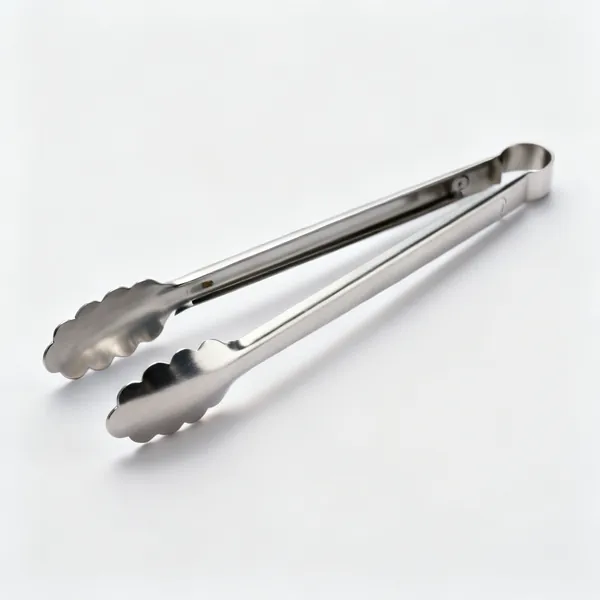 A pair of stainless steel kitchen tongs with scalloped ends