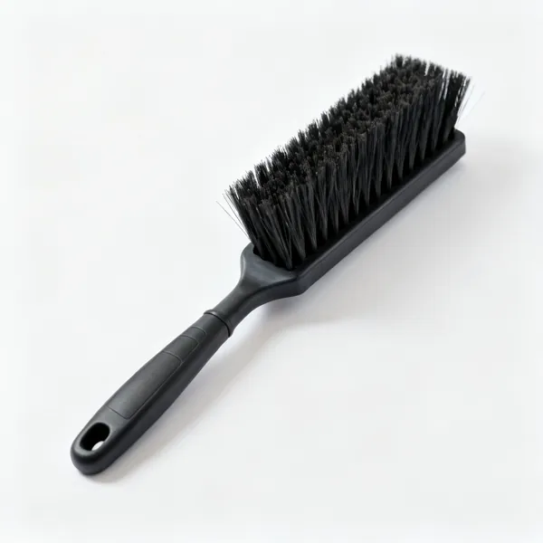 A stiff bristled yard brush
