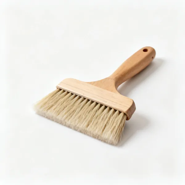 A wide soft bristled wallpaper smoothing brush with a wooden handle