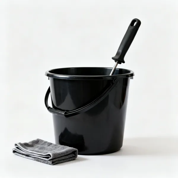 Bucket and cloths: A black plastic bucket with a folded cloth beside it