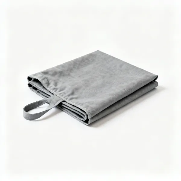 A grey fibreglass welding spark blanket, partly folded