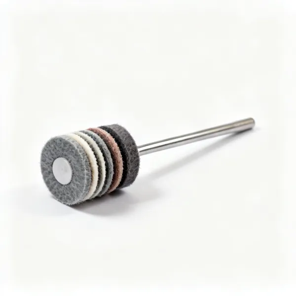 A set of small felt and cloth rotary tool polishing wheels with a mandrel