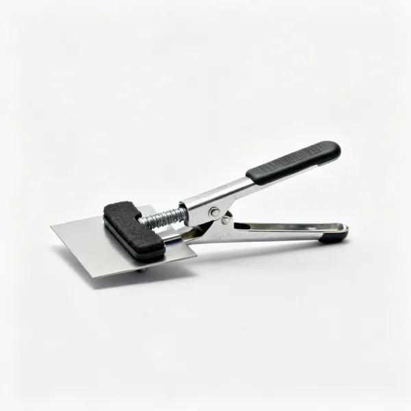 Sheet clamps: A pair of small metal sheet holding clamps with rubber pads and screw handles