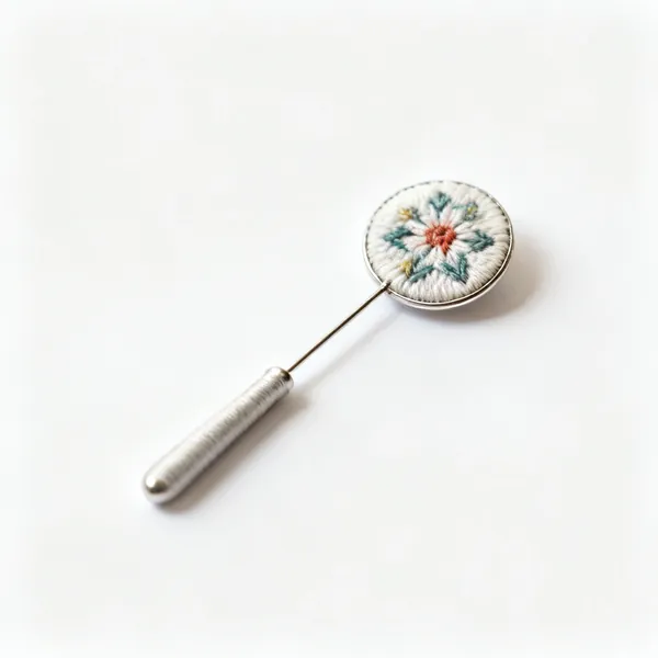 A small decorative magnetic needle minder disc on fabric