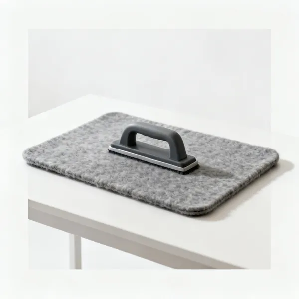 A thick grey wool pressing mat lying flat on a table