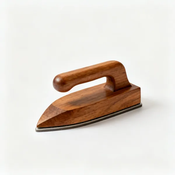 A shaped hardwood tailor's clapper pressing block