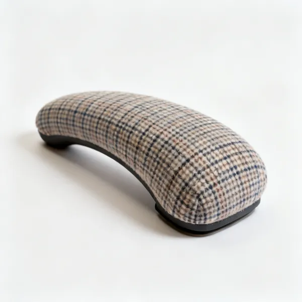 A firm curved tailor's ham pressing cushion with checked wool fabric