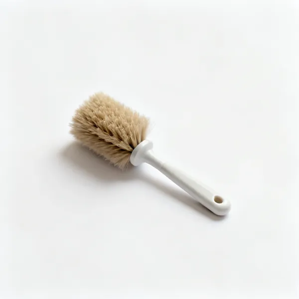 A small stiff lint brush for a sewing machine