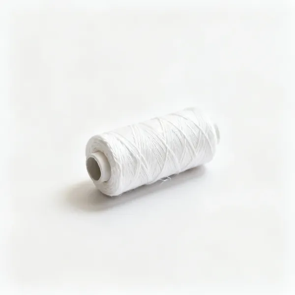 A reel of white cotton basting thread