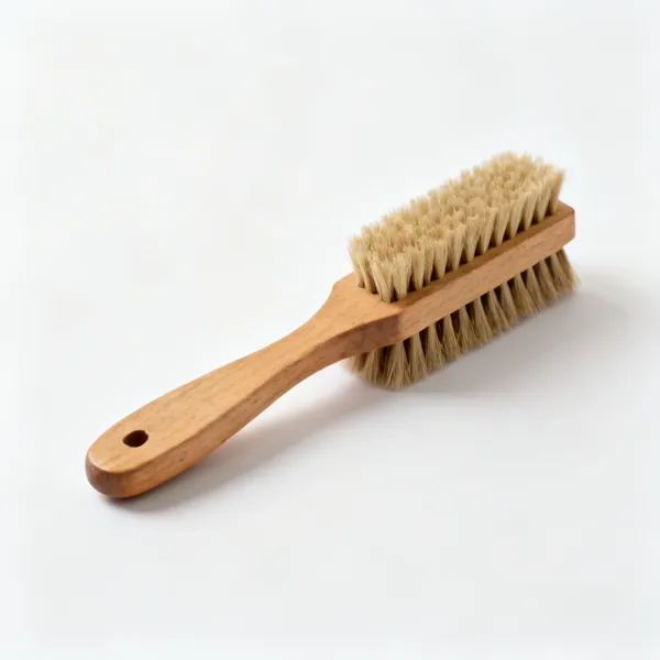 A wooden handled bench brush with stiff bristles